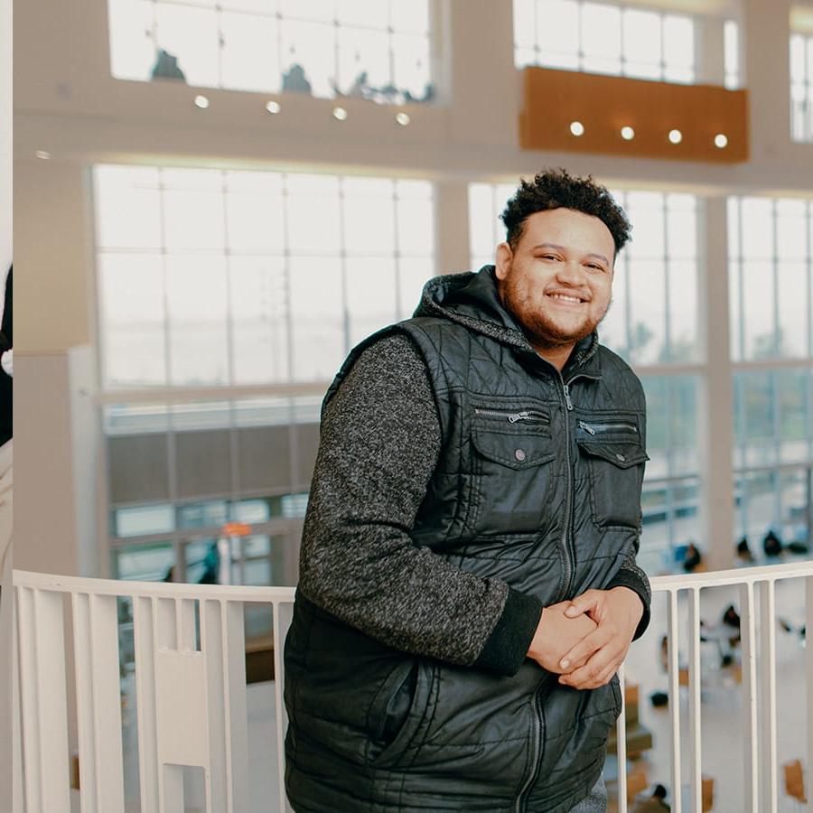 Student poses in front of ISC railing.